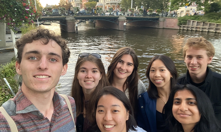 Group of students in front of a bridge over a canal in Amsterdam