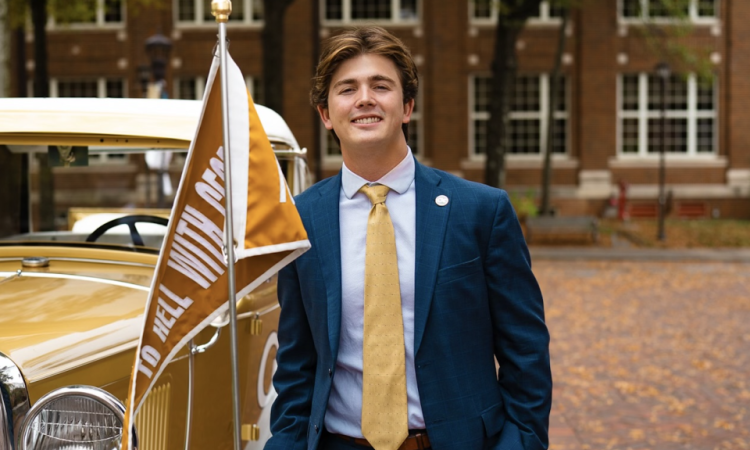 Harrison Baro stands next to the Ramblin' Wreck at Georgia Tech 