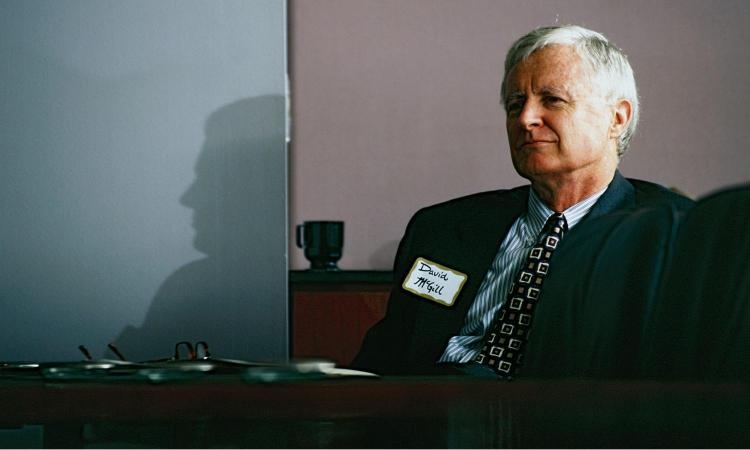 A photo of David McGill seated at a desk