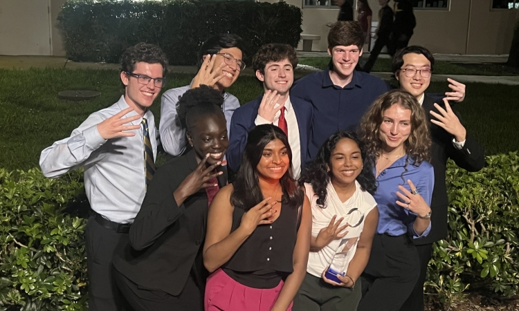 The 2026 GT-ASCE Sustainable Solutions teams poses with their award all holding up four fingers to signify their 4th win