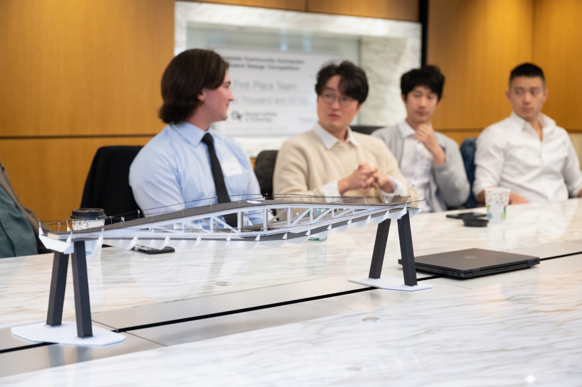 Issac Wasson and Charles Kim present their final bridge design to President Angel Cabrera