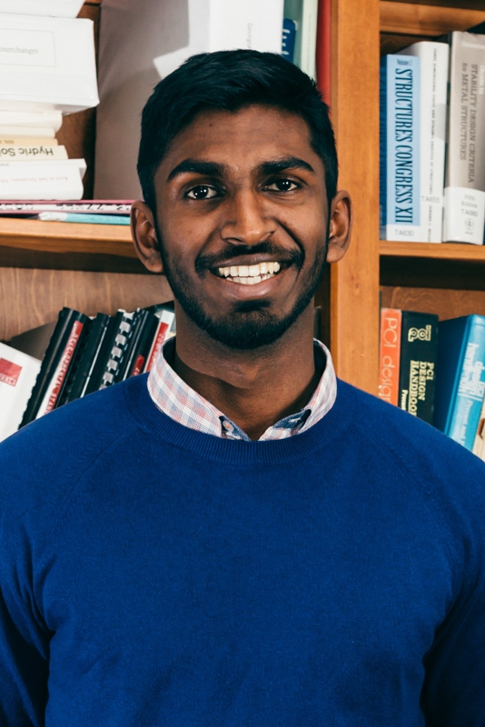 Headshot of man in front of a bookcase