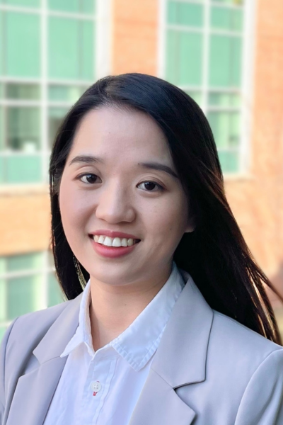 A headshot of a woman in a blazer