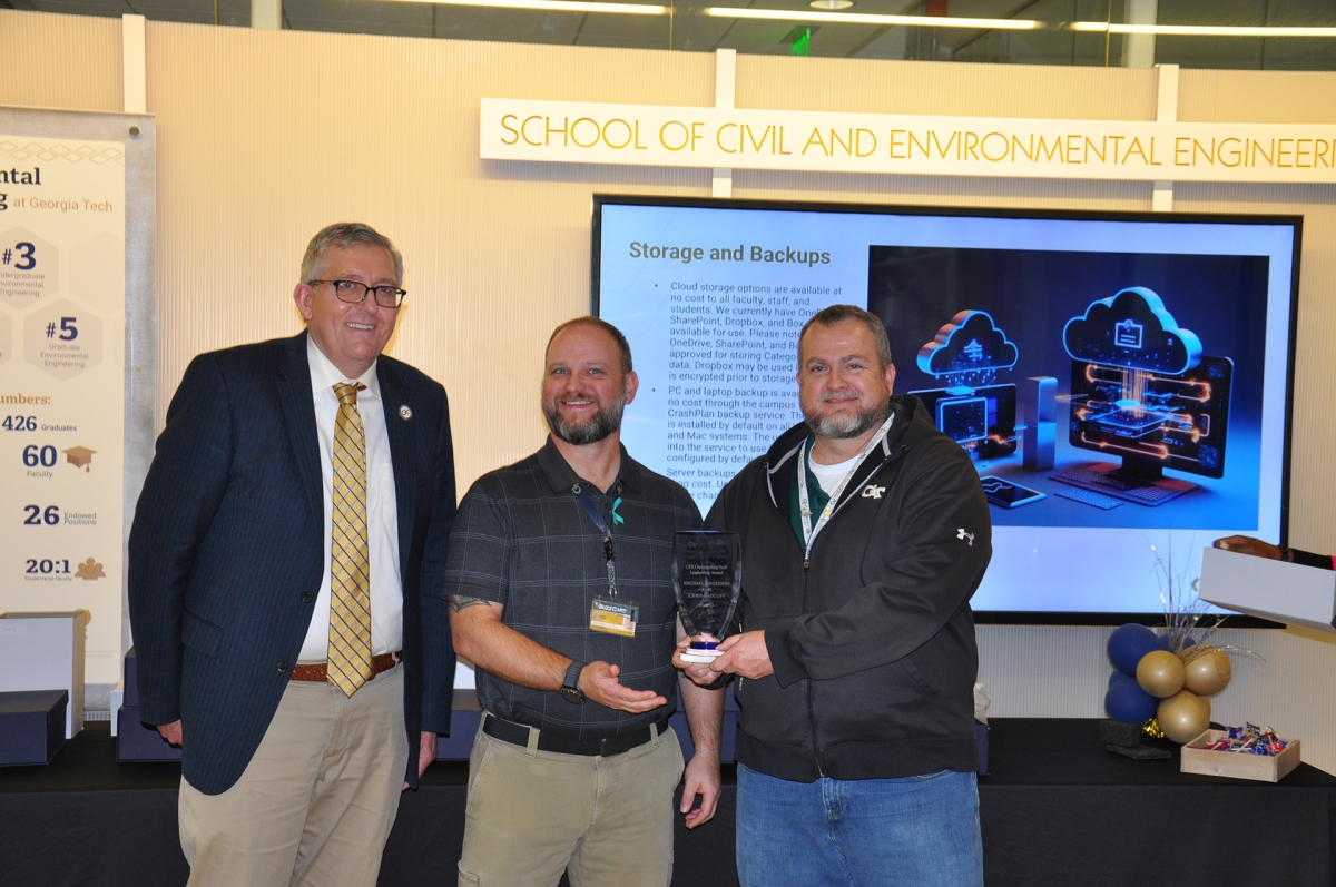 Chair Don Webster with Chris Radcliff and Mike Anderson holding their award