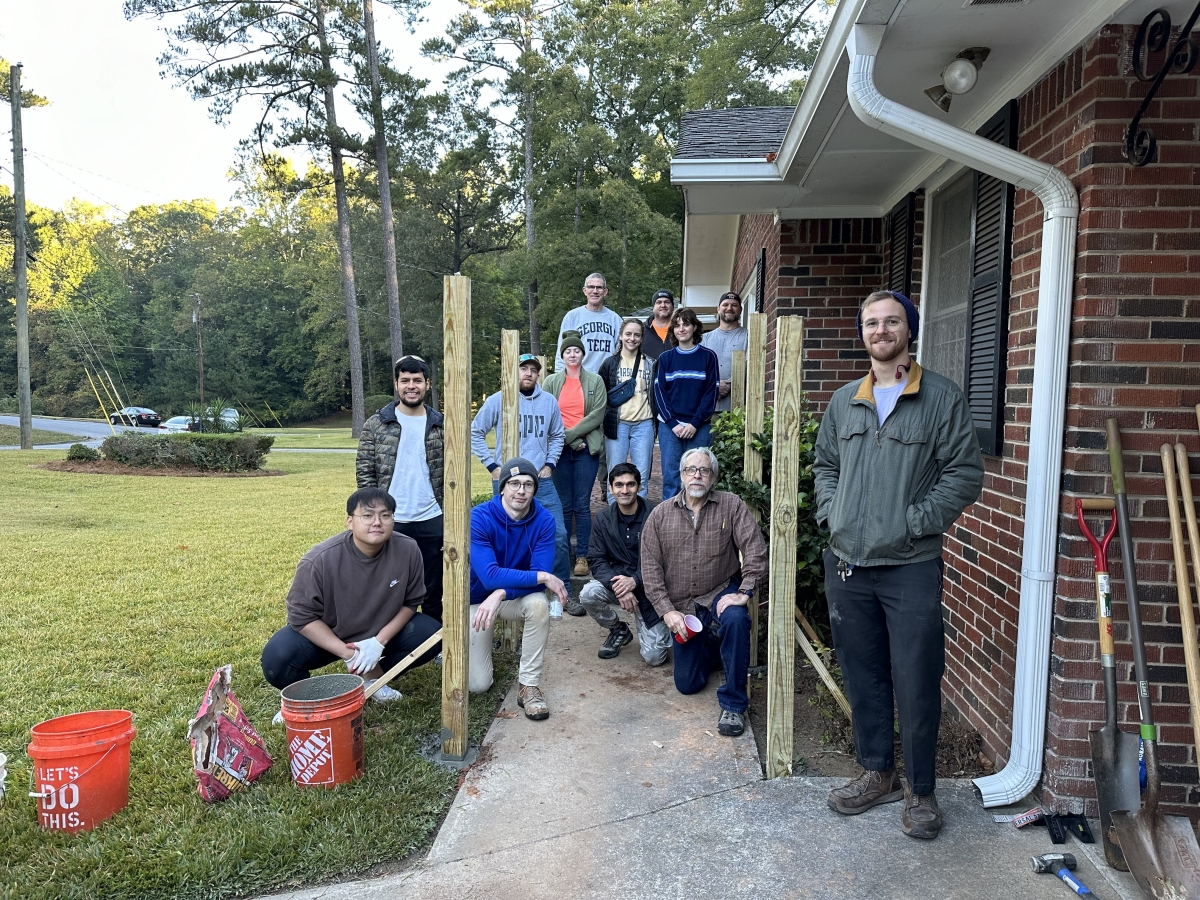 Saturday crew of staff members and students pose with posts for ramp