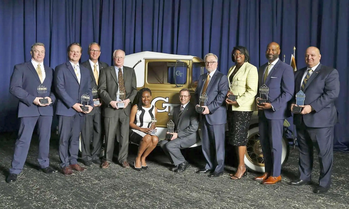 Group of Distinguished Engineering Alumni honorees in front of the Ramblin’ Wreck