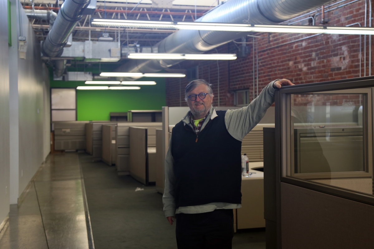 A man standing in an industrial office space