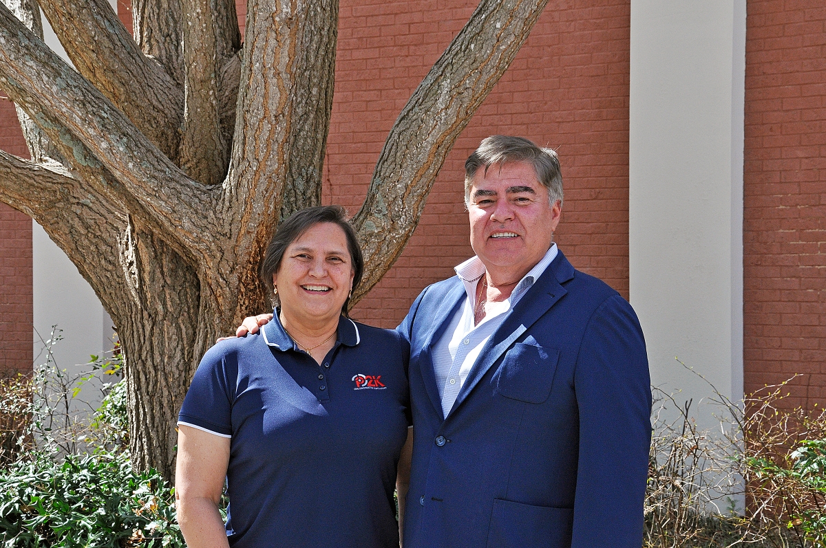 Portrait of Guimar and Carlos Obregon in front of a tree outside the Mason building
