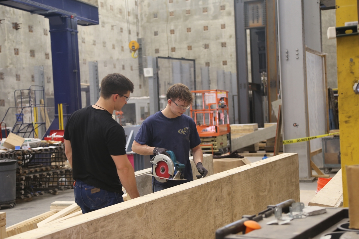 two men working with power tools 