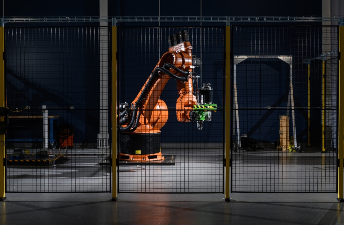 An orange piece of equipment at a manufacturing facility