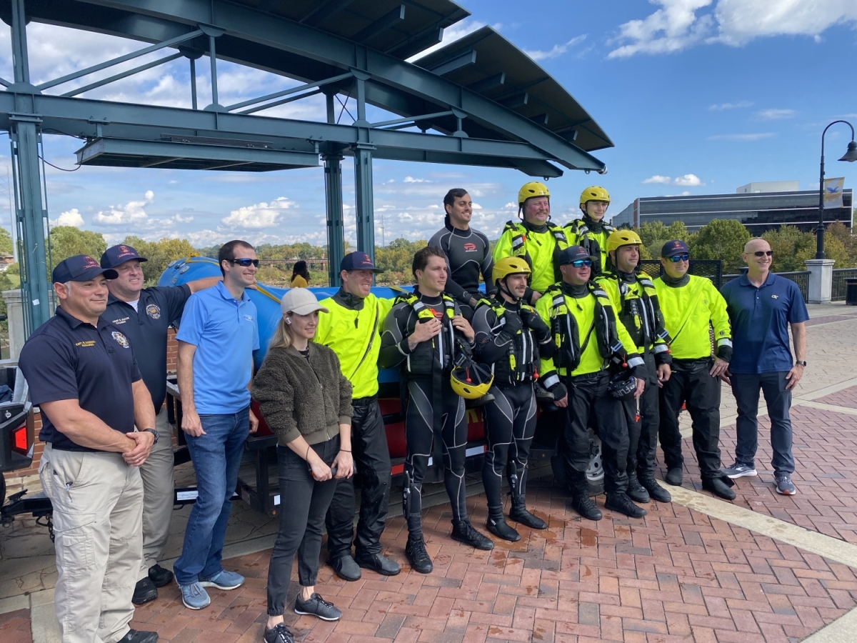 A group of divers and researchers pose in front of a boat in Columbus, Georgia.