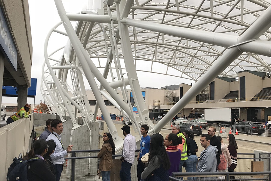 McCarthy Building Company Project Manager Justis Brogan tells a group of School of Civil and Environmental Engineering students about the canopies being installed at Hartsfield-Jackson Atlanta International Airport. Teams of students and industry mentors spent a day brainstorming ways to use robotics to improve the installation as part of the School's second Tech Blitz Nov. 9. (Photo: Eric Marks)