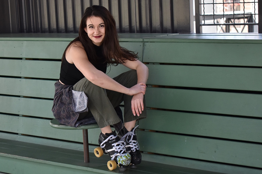 Guiliana Stovall sits on a bench with her roller derby roller skates. Stovall, a long-time roller derby player, knew she would continue to skate when she came to Georgia Tech. And since Tech had no outlet, she founded Yellow Jacket Roller Derby. (Photo Courtesy: Giuliana Stovall)