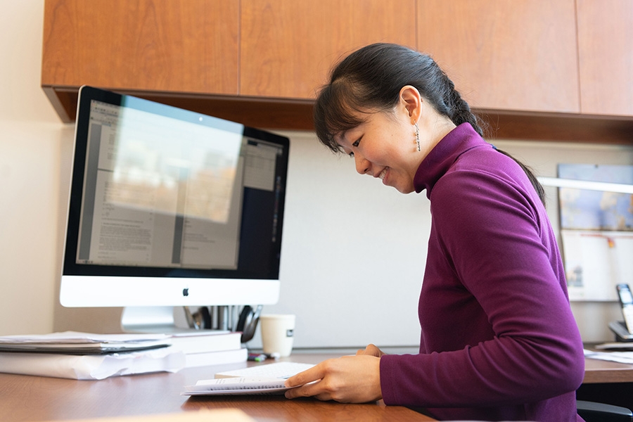 Assistant Professer Iris Tien sits at her desk in her Georgia Tech office. (Photo: Allison Carter)