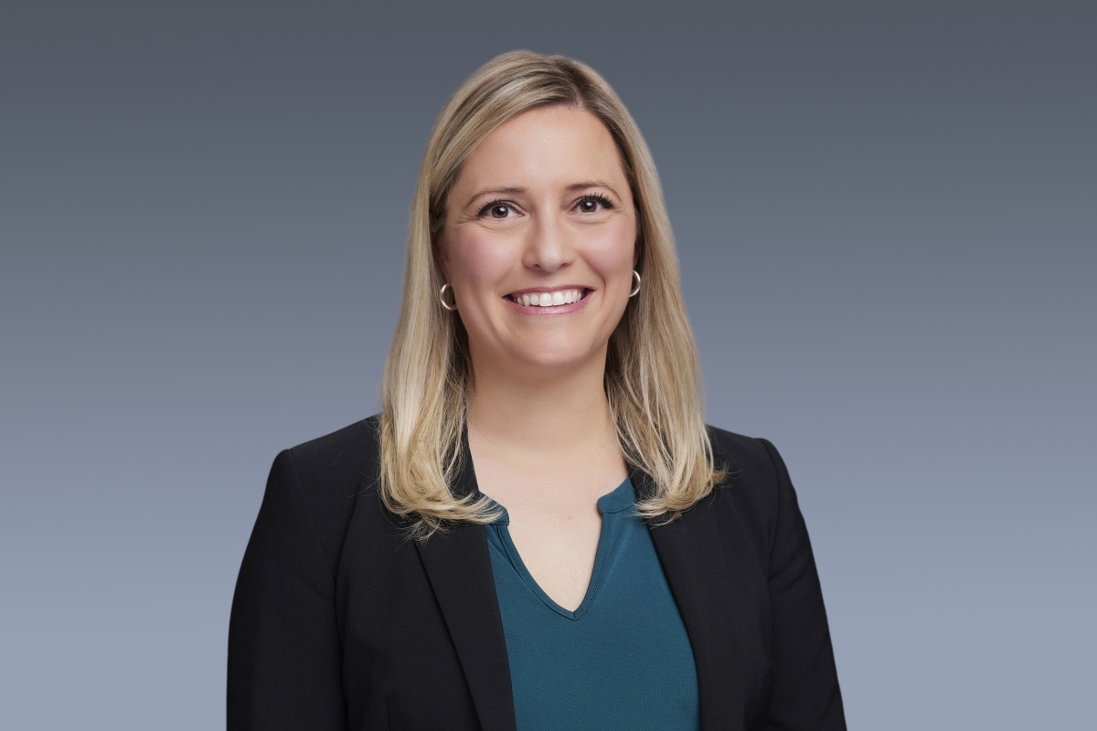 Portrait of Kate Henry in a blue blouse and black blazer