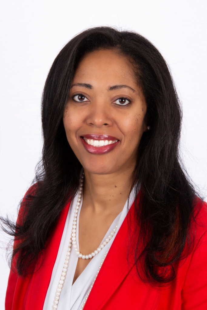 Portrait of Stacy Blakley in a white shirt with a red blazer