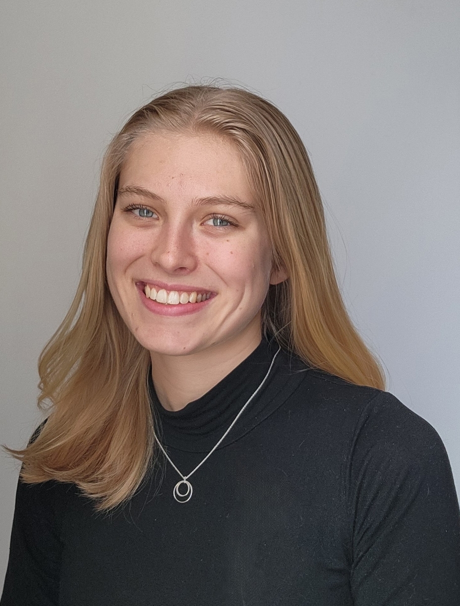 Portrait of Nina Roush in a dark grey blouse with a silver necklace